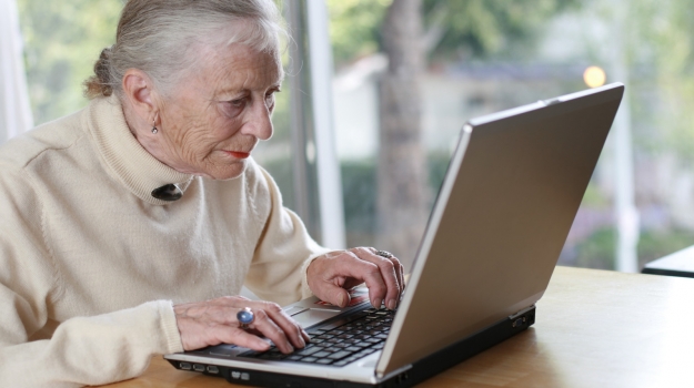 senior woman typing on laptop
