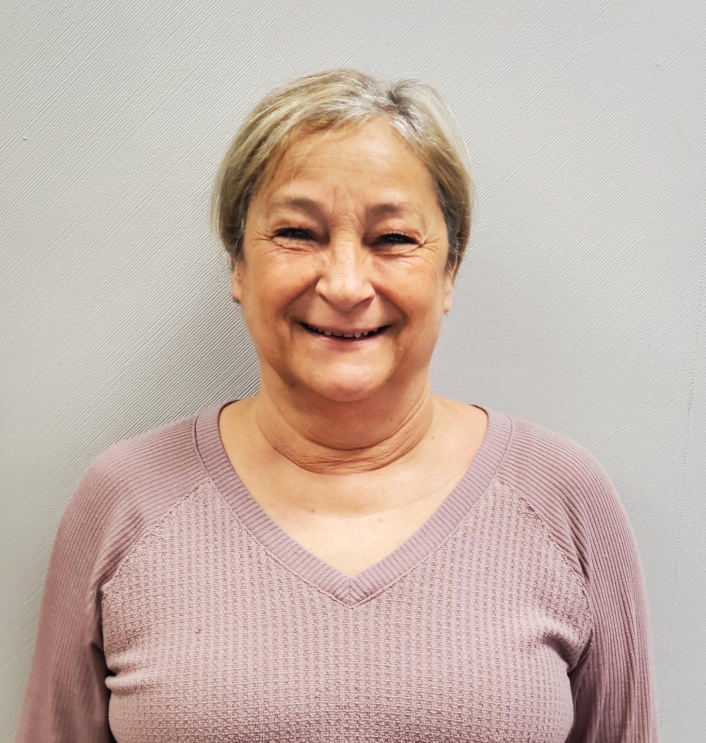 Elder woman with short hair smiling