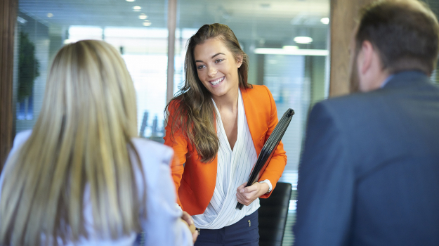 Woman at an office shaking hands