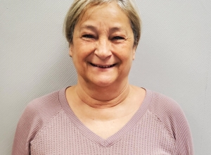 Elder woman with short hair smiling